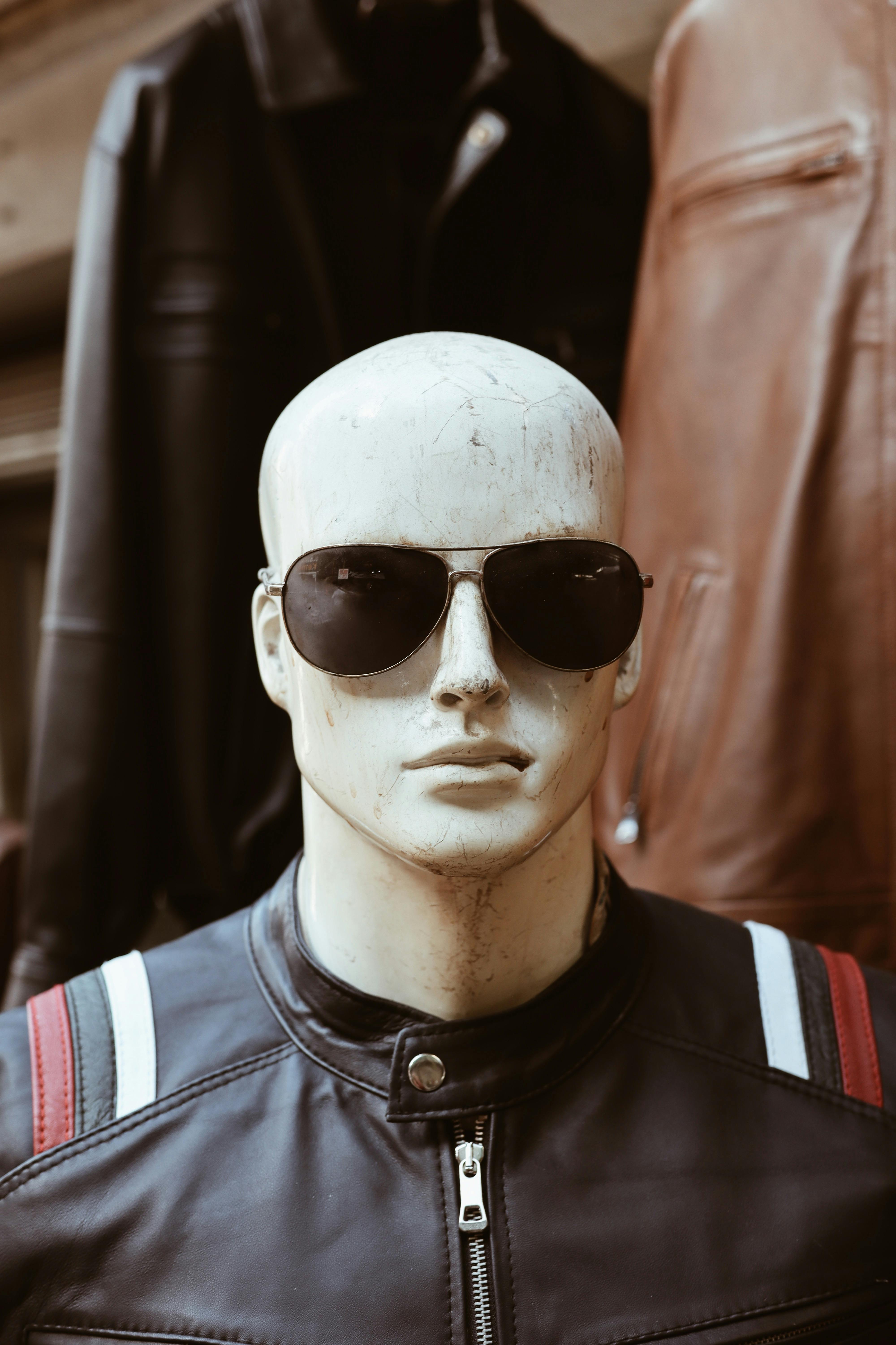 Vintage aviator sunglasses on a dark leather surface