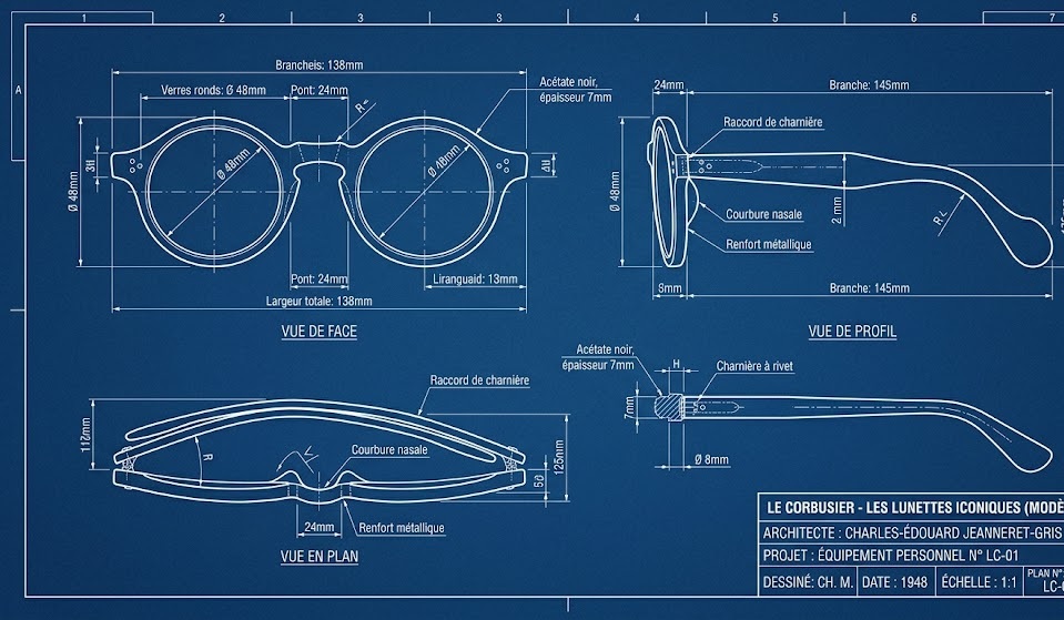 Round black eyeglasses on an architectural blueprint or concrete surface